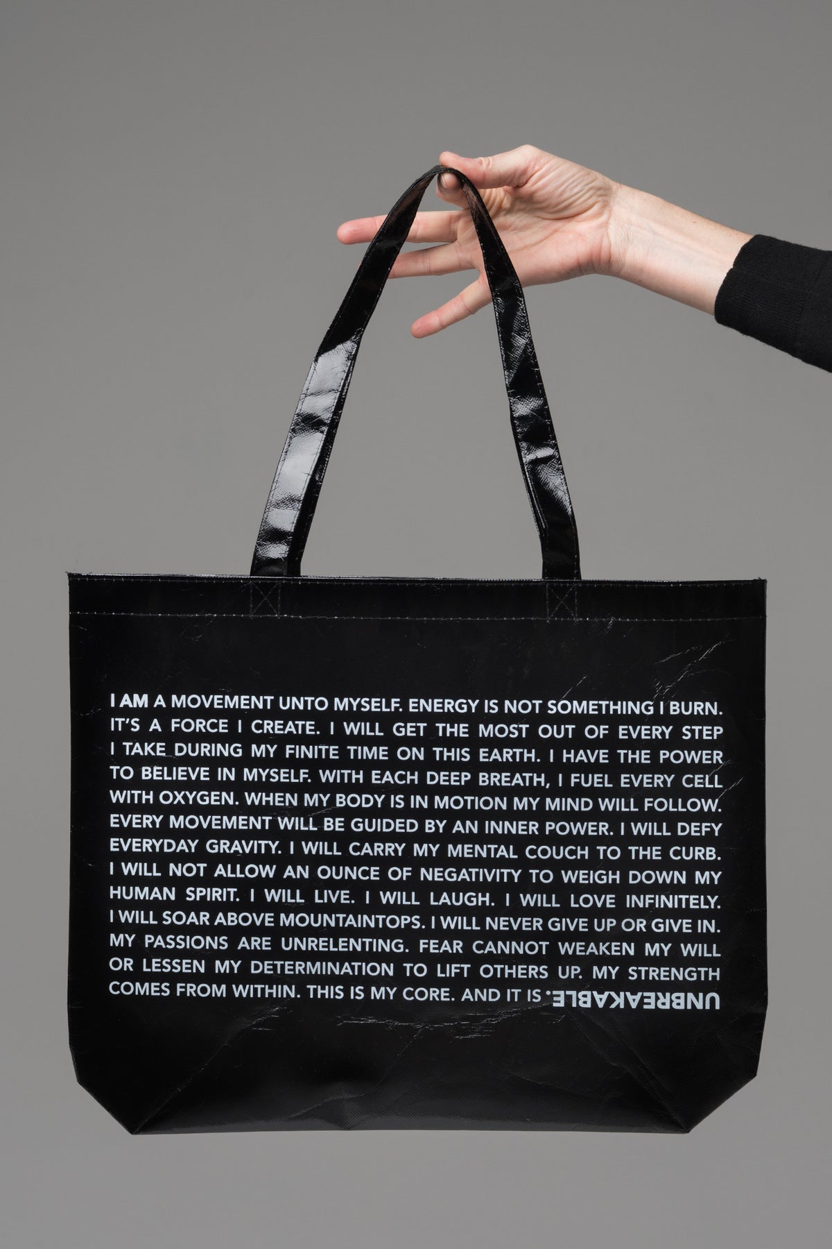 UNBREAKABLE. Laminated Tote Bag