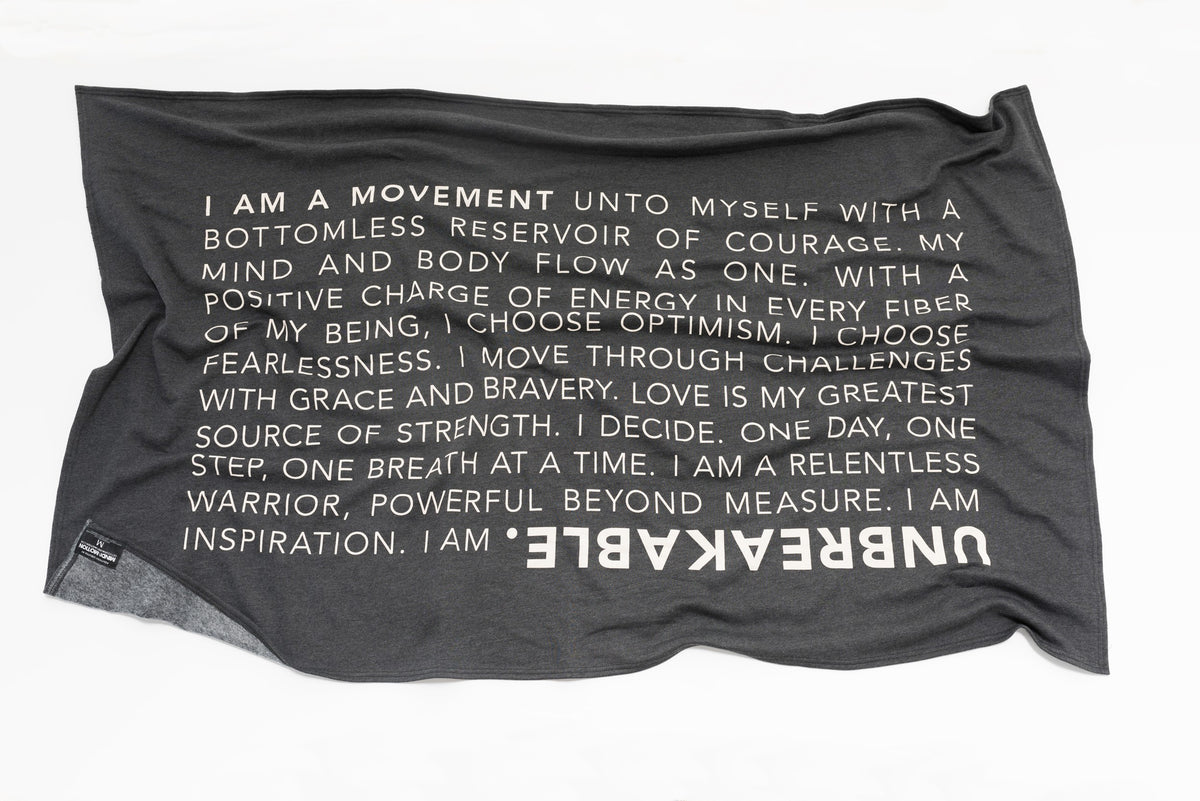Extra soft, polycotton blended fleece blanket with UNBREAKABLE manifesto. Grey.